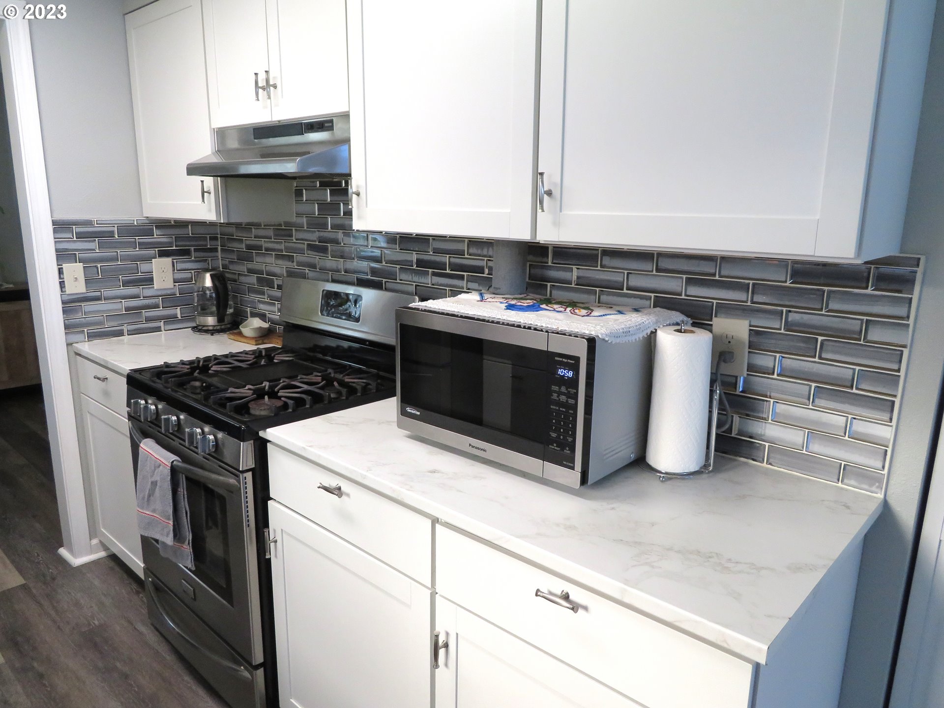 4440 Southwest 194th Court Beaverton, OR 97078 - Photo 11 of 32 a kitchen with stainless steel appliances granite countertop a stove and a sink
