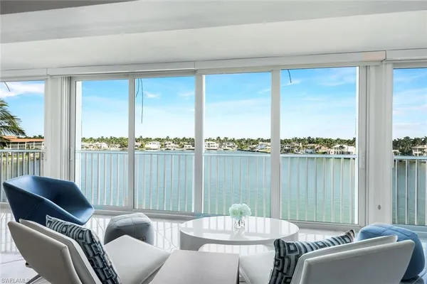 a living room with furniture table and chairs