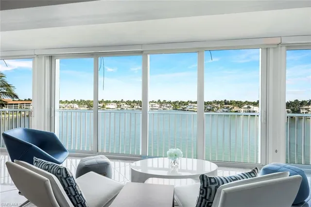 a living room with furniture table and chairs