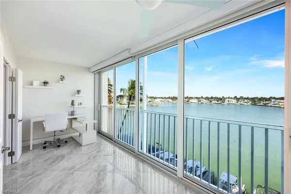 a view of a balcony with chair and floor to ceiling window