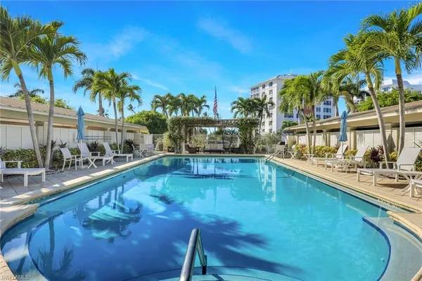 a swimming pool with outdoor seating and yard