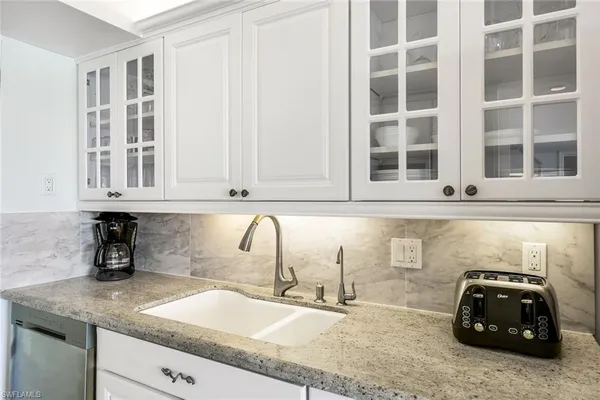 a kitchen with a sink and a window