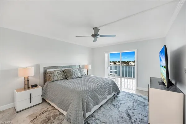 a bedroom with a large bed and a flat screen tv