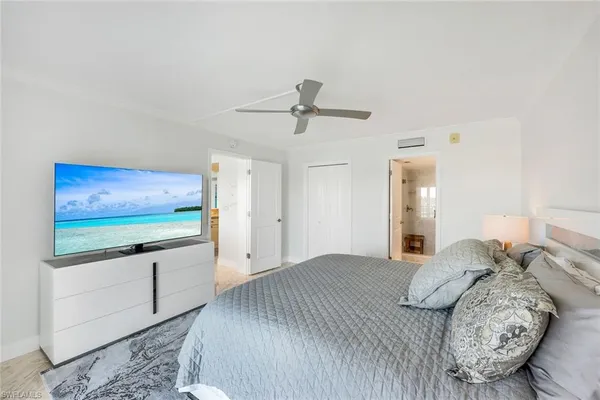 a bedroom with furniture and a flat screen tv