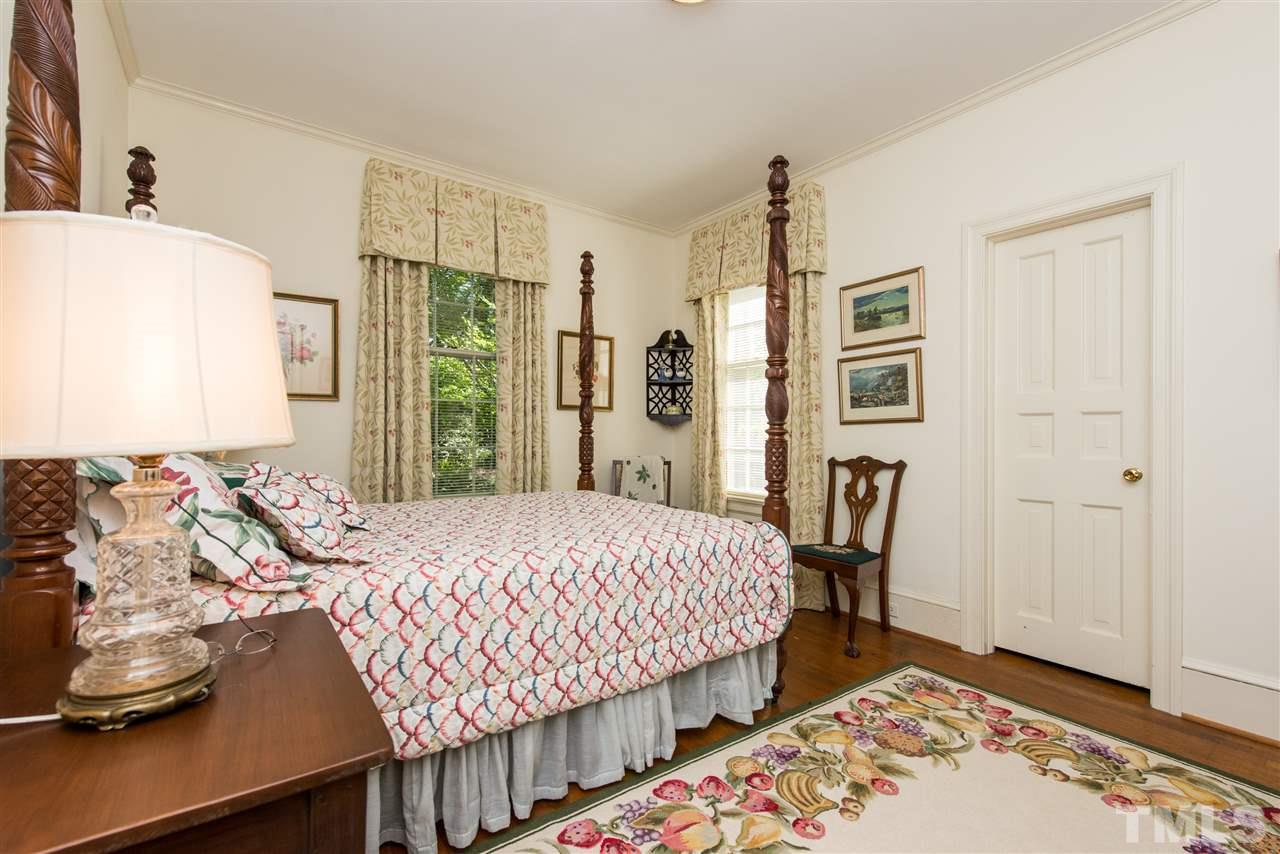2503 Wake Drive Raleigh, NC 27608 - Photo 13 of 24 a bedroom with a bed and wooden floor