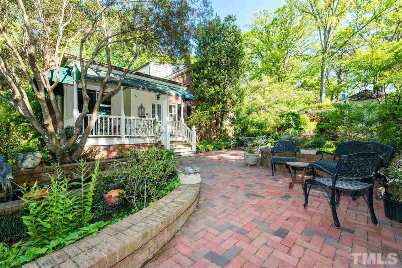 2503 Wake Drive Raleigh, NC 27608 - Photo 17 of 24 a front view of a house with a garden and outdoor seating
