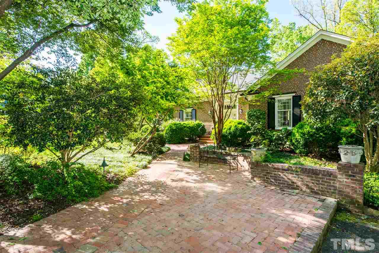 2503 Wake Drive Raleigh, NC 27608 - Photo 24 of 24 a view of a patio with table and chairs and potted plants with large tree