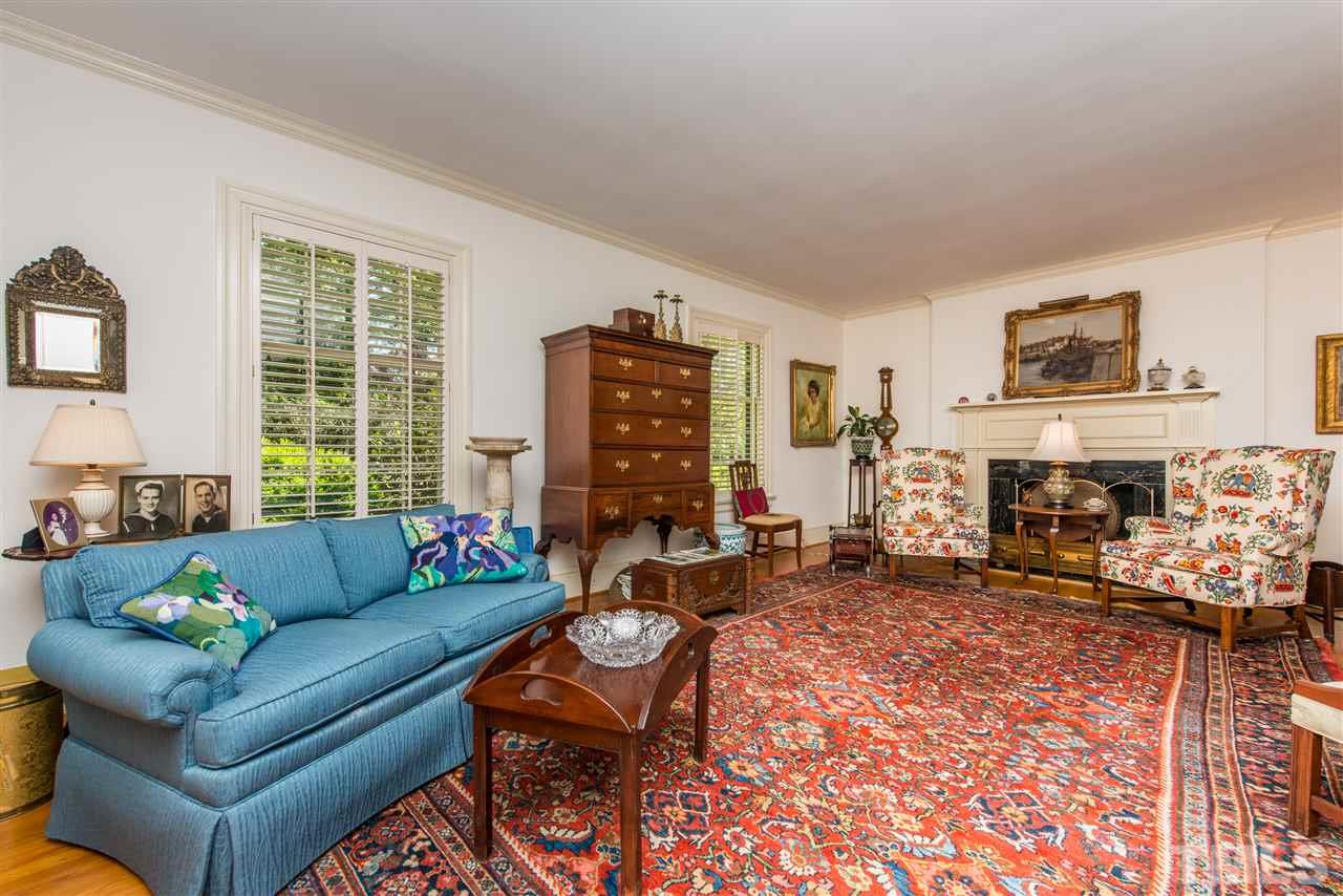2503 Wake Drive Raleigh, NC 27608 - Photo 5 of 24 a living room with furniture large window and a fireplace