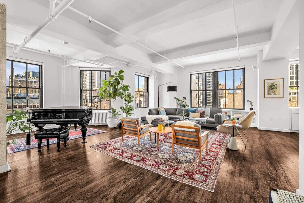 11 West 30th Street, Unit 14 Manhattan, NY 10001 - Photo 3 of 18 a living room with furniture and wooden floor