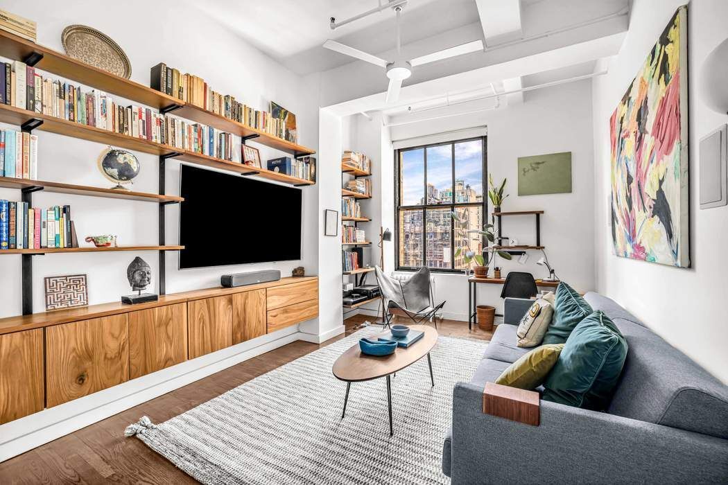 11 West 30th Street, Unit 14 Manhattan, NY 10001 - Photo 8 of 18 a living room with furniture and a flat screen tv