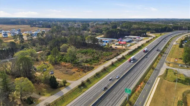 an aerial view of residential houses with city view