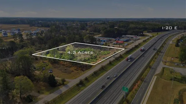 a view of a city from a balcony with furniture