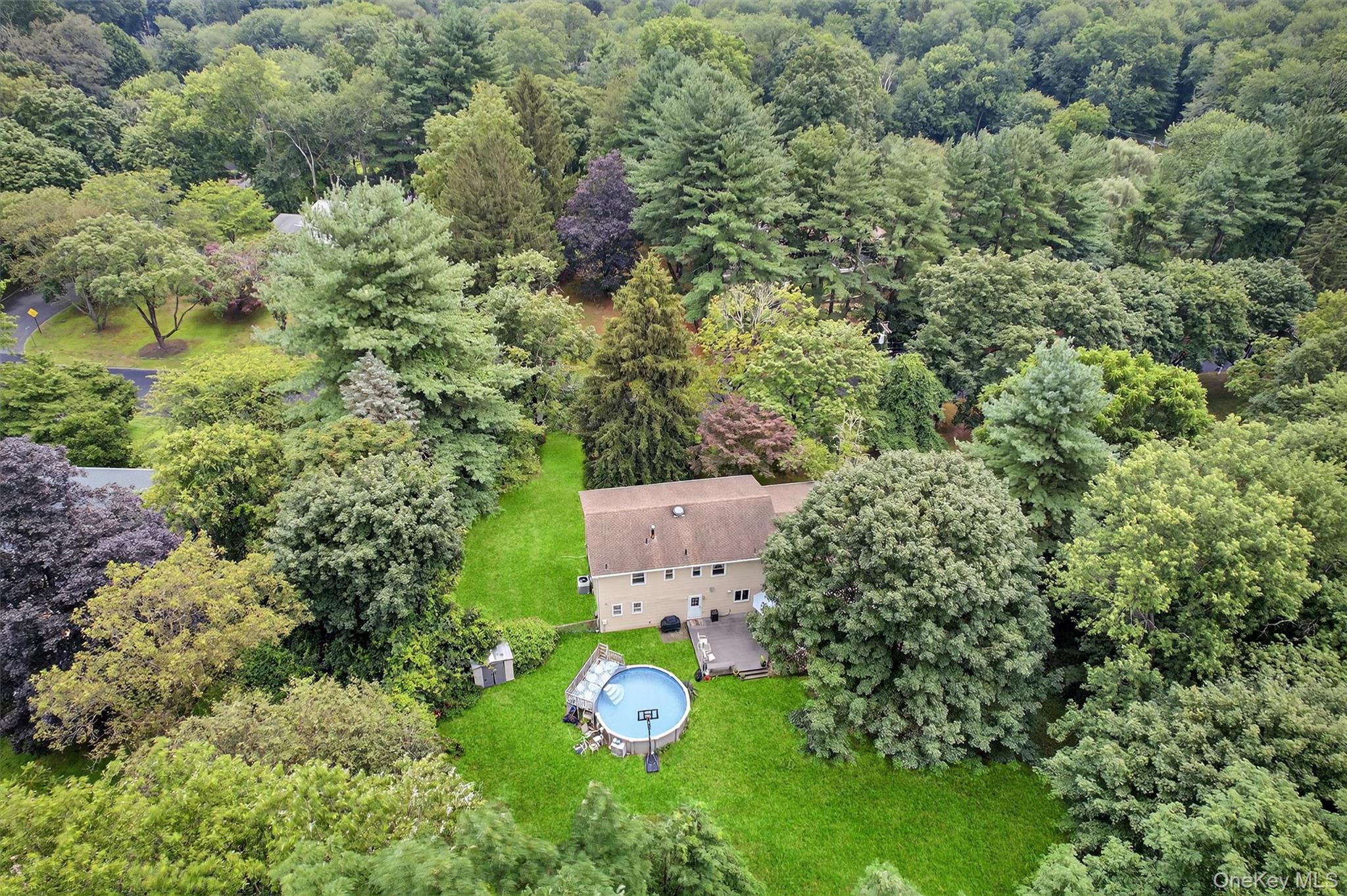 an aerial view of a house with yard