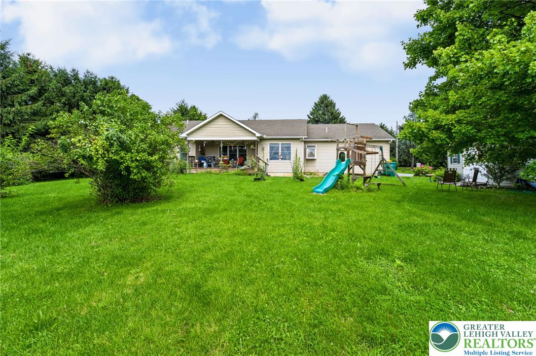 6970 Silver Crest Road Nazareth, PA 18064 - Photo 31 of 35 A verdant lawn provides a natural setting for this inviting home featuring a welcoming back porch.