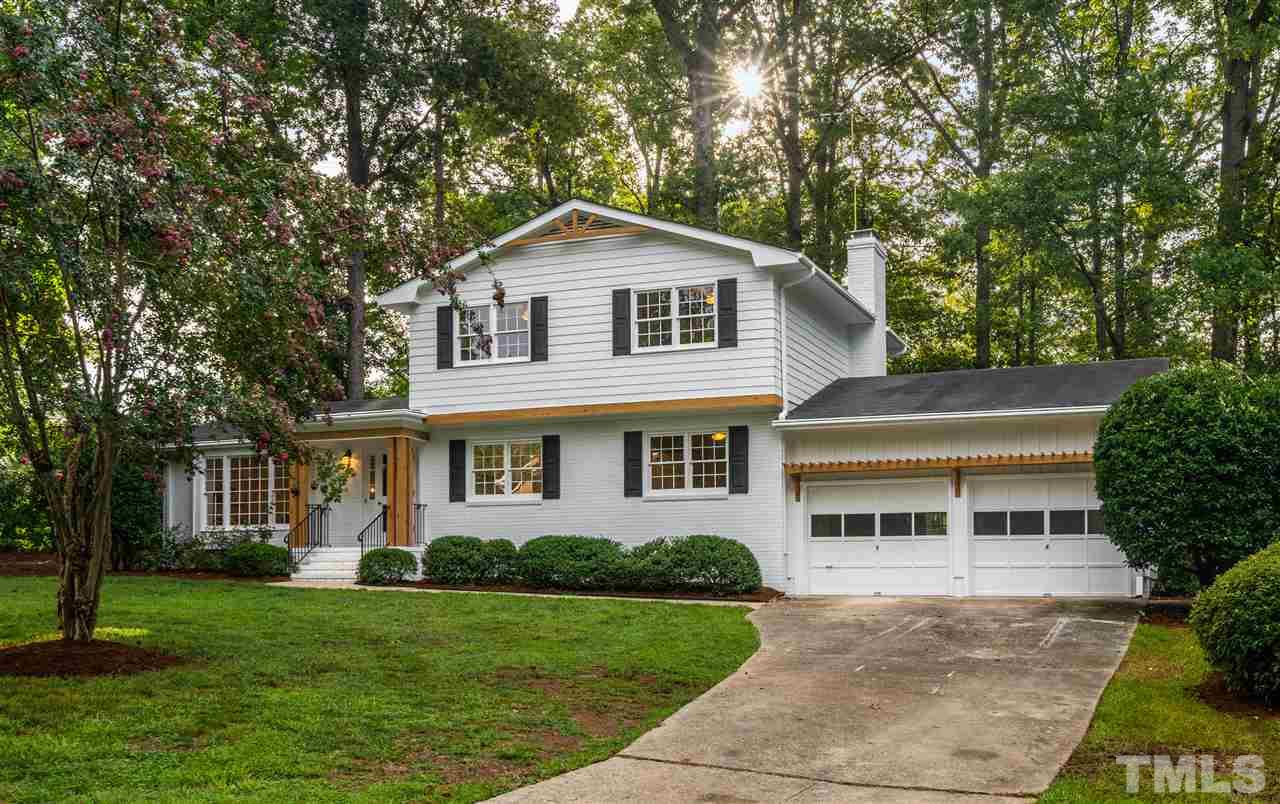 4012 Colby Drive Raleigh, NC 27609 - Photo 3 of 23 a front view of a house with a yard and garage