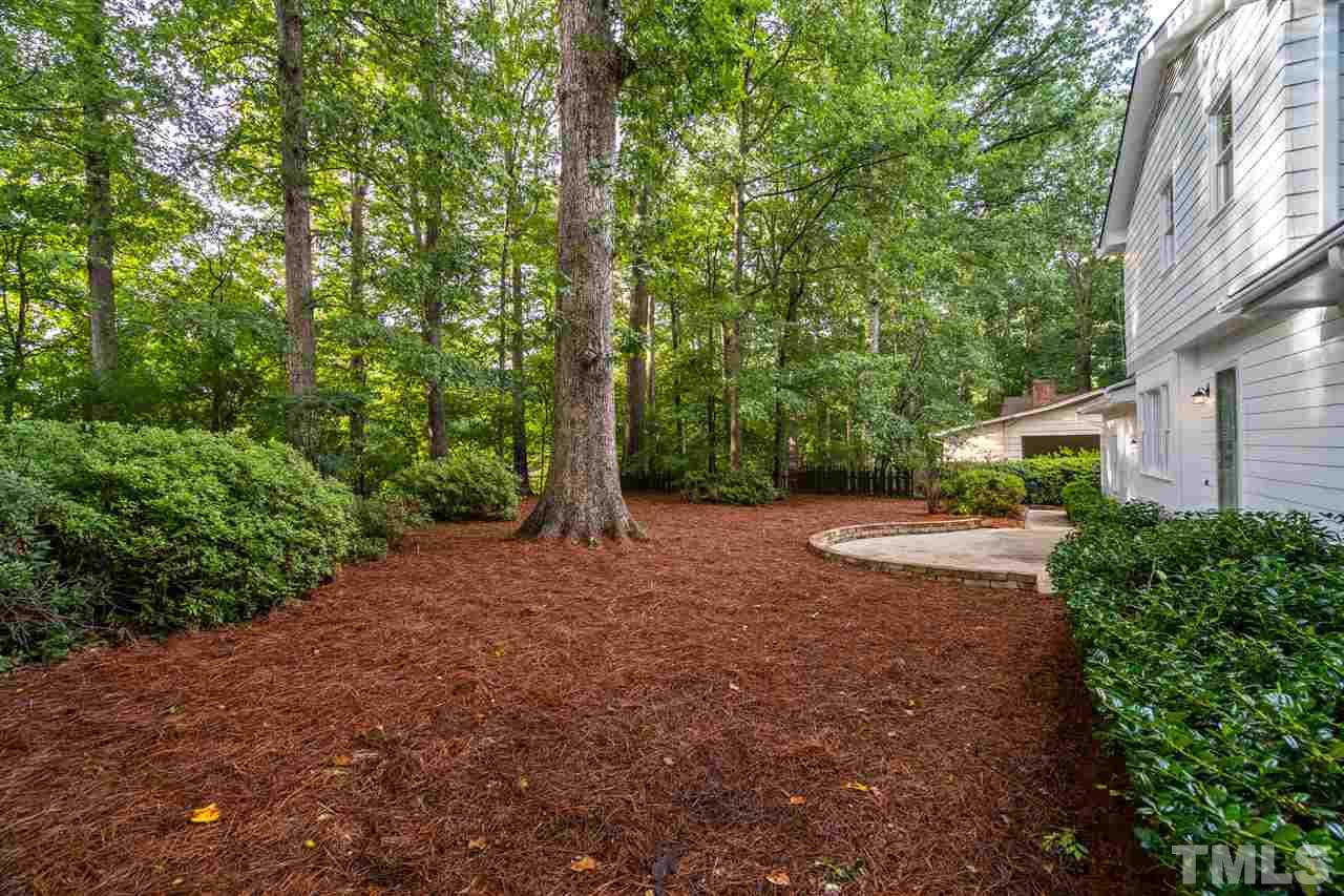 4012 Colby Drive Raleigh, NC 27609 - Photo 22 of 23 a view of a street with trees and bushes