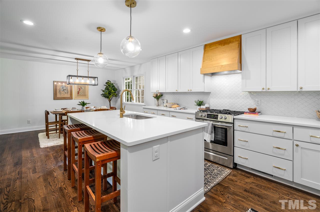 4012 Colby Drive Raleigh, NC 27609 - Photo 8 of 23 a kitchen with a sink cabinets and wooden floor