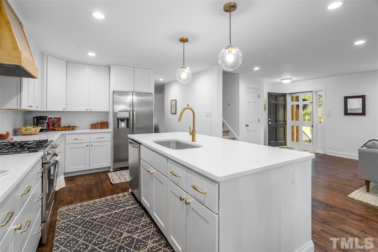 4012 Colby Drive Raleigh, NC 27609 - Photo 9 of 23 a kitchen that has a lot of cabinets in it and wooden floors