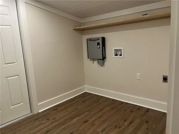 a view of a room with wooden floor