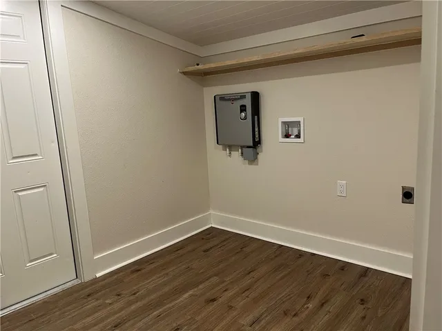 a view of a room with wooden floor