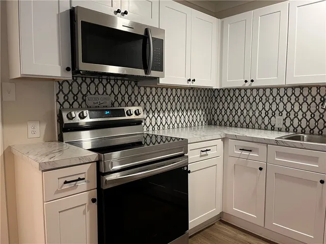 a kitchen with microwave cabinets and stove