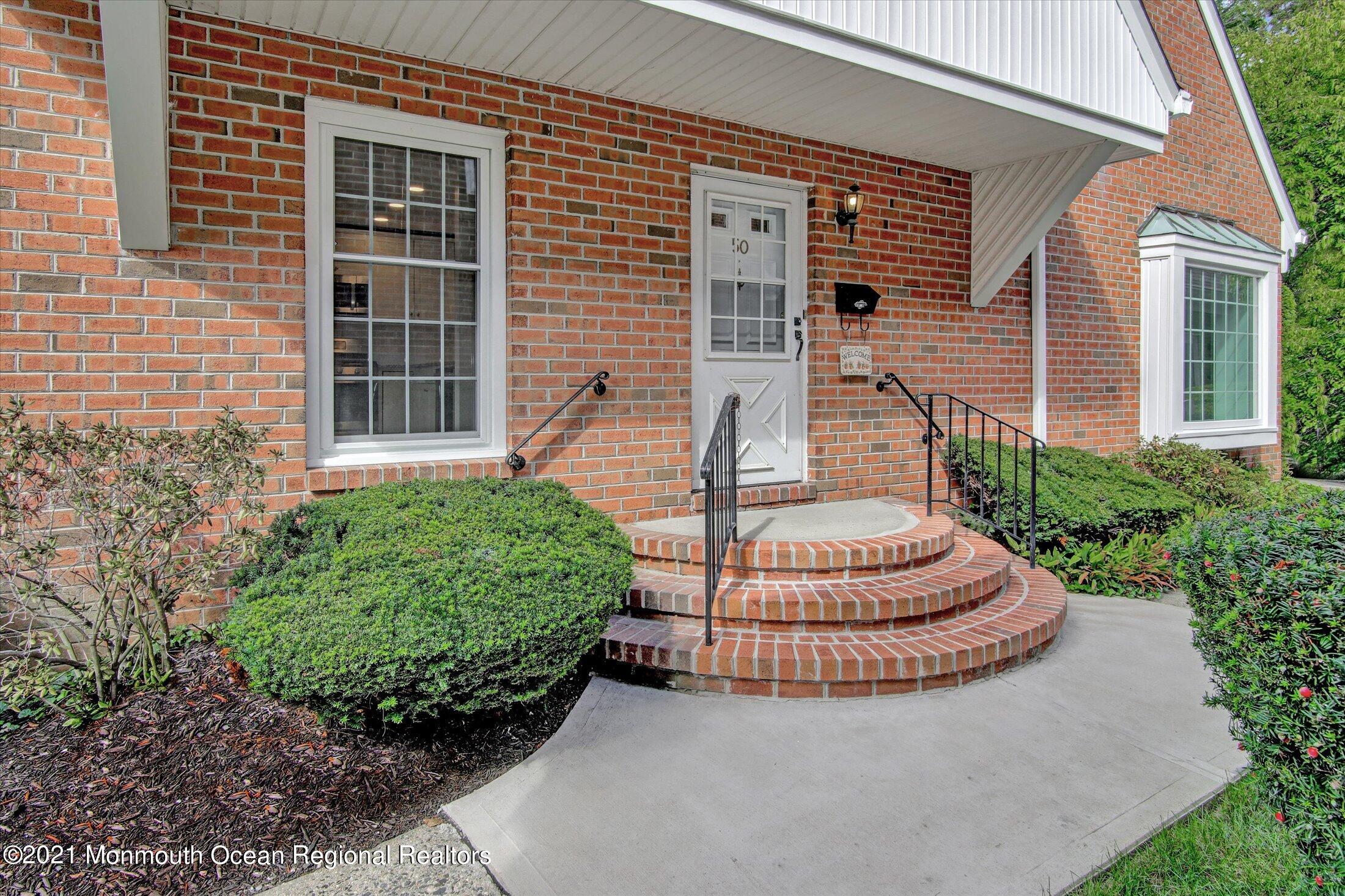 50 Wyckham Road Spring Lake Heights, NJ 07762 - Photo 1 of 27 front view of a house with a fountain and a fountain