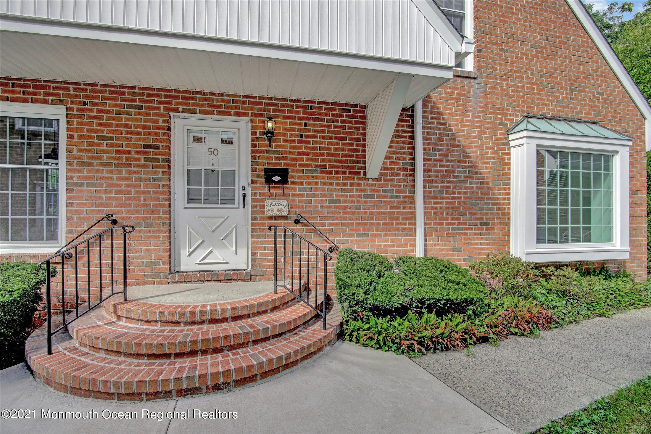 50 Wyckham Road Spring Lake Heights, NJ 07762 - Photo 2 of 27 a view of a house with a wooden bench