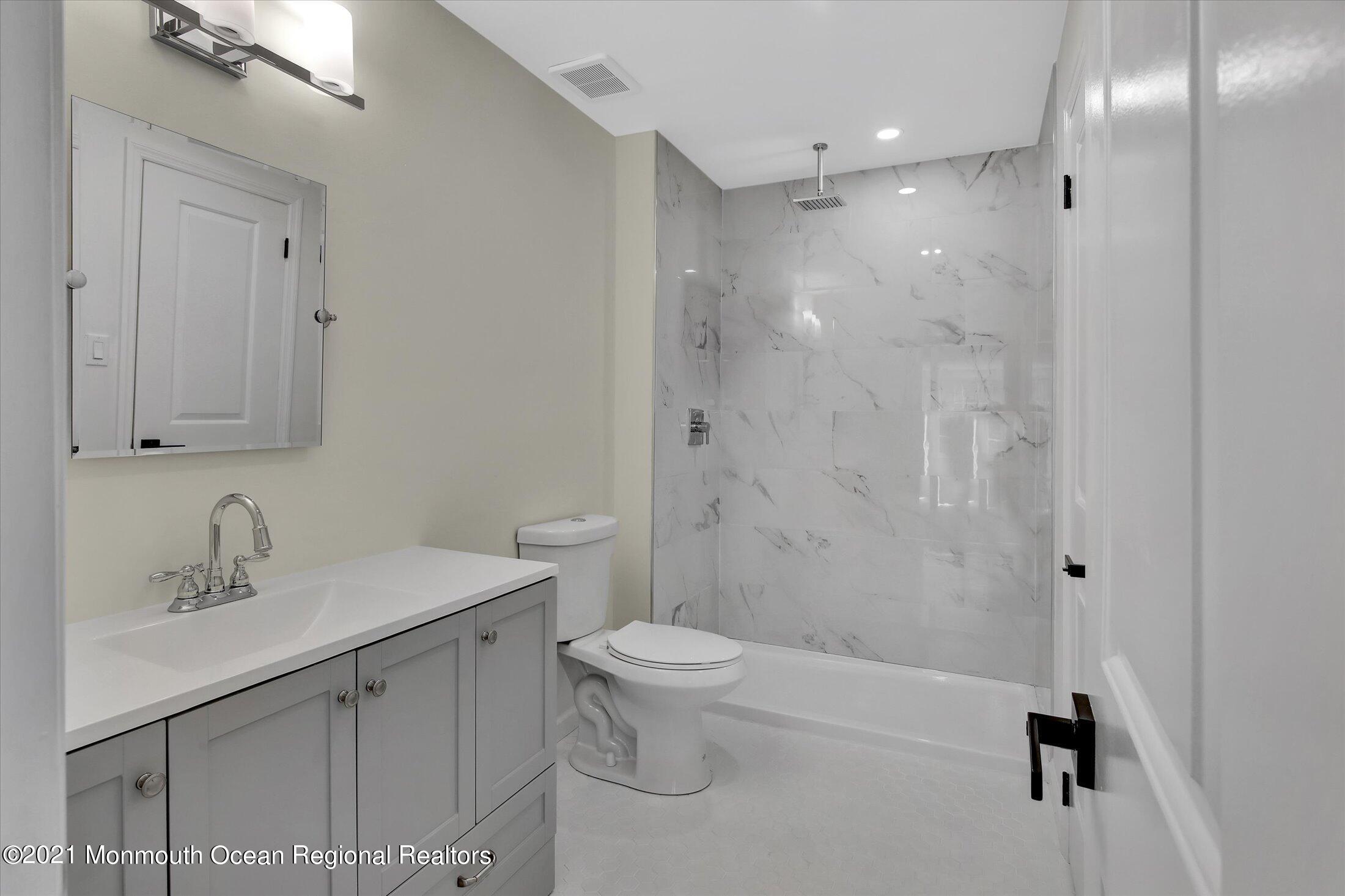 50 Wyckham Road Spring Lake Heights, NJ 07762 - Photo 14 of 27 a bathroom with a sink a toilet and shower