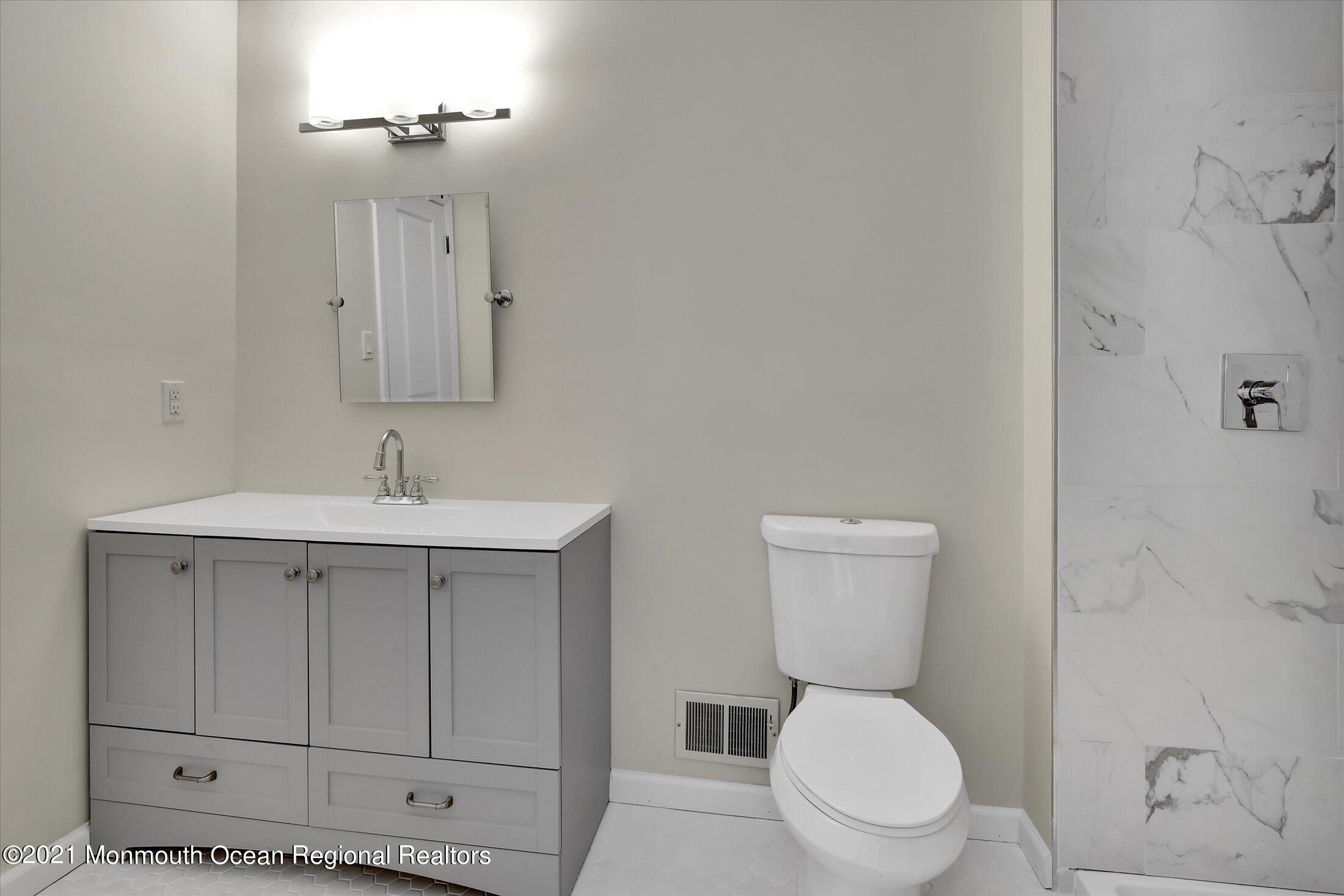 50 Wyckham Road Spring Lake Heights, NJ 07762 - Photo 15 of 27 a white toilet sitting next to a bathroom sink