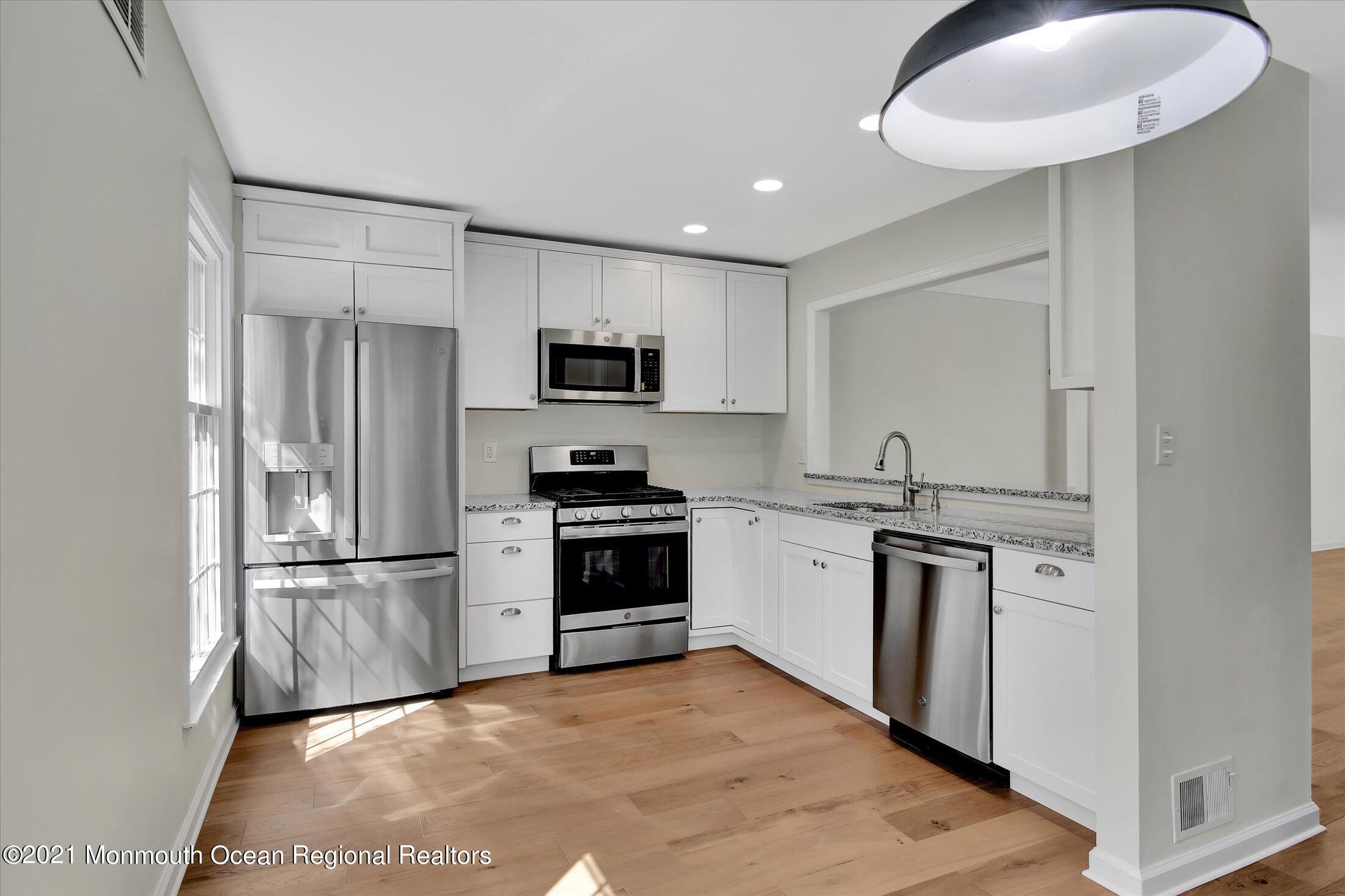 50 Wyckham Road Spring Lake Heights, NJ 07762 - Photo 3 of 27 a kitchen with kitchen island a sink stainless steel appliances and cabinets