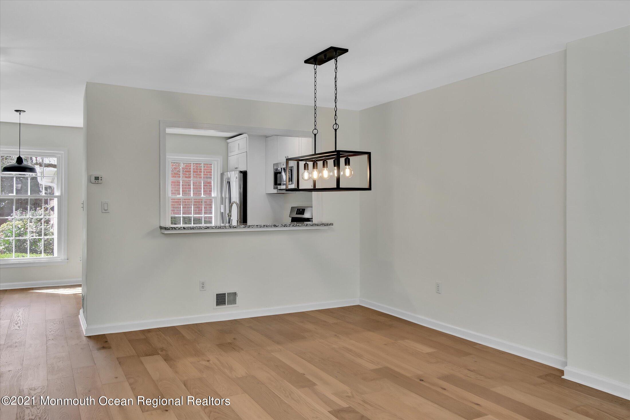 50 Wyckham Road Spring Lake Heights, NJ 07762 - Photo 8 of 27 a view of an empty room with wooden floor and a window