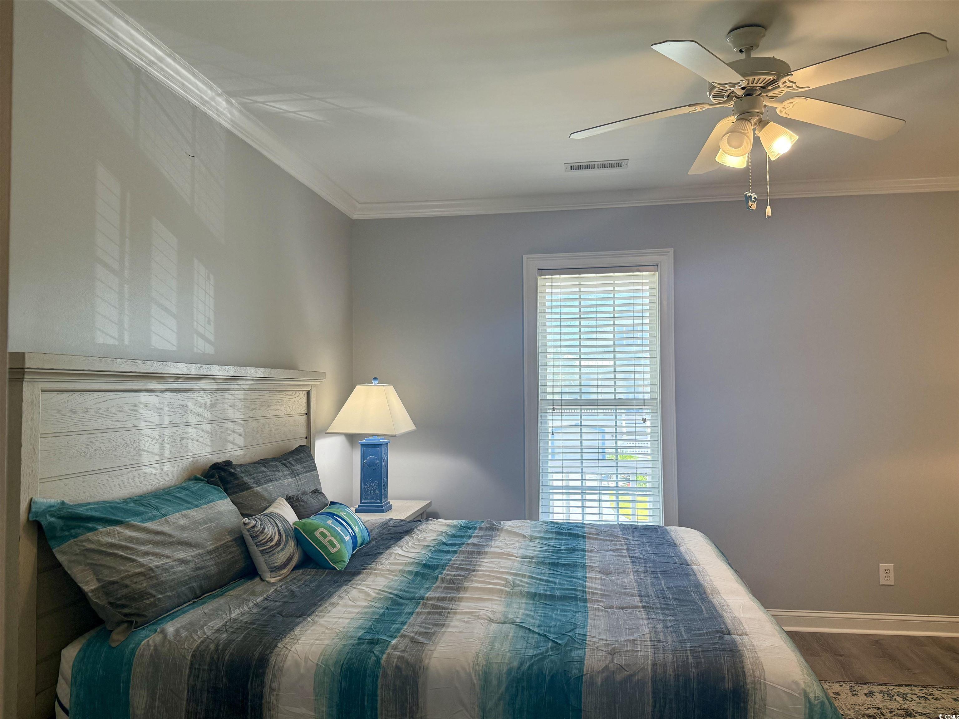 118 Georges Bay Road Murrells Inlet, SC 29576 - Photo 13 of 39 Bedroom featuring crown molding, wood finished floors, and a ceiling fan