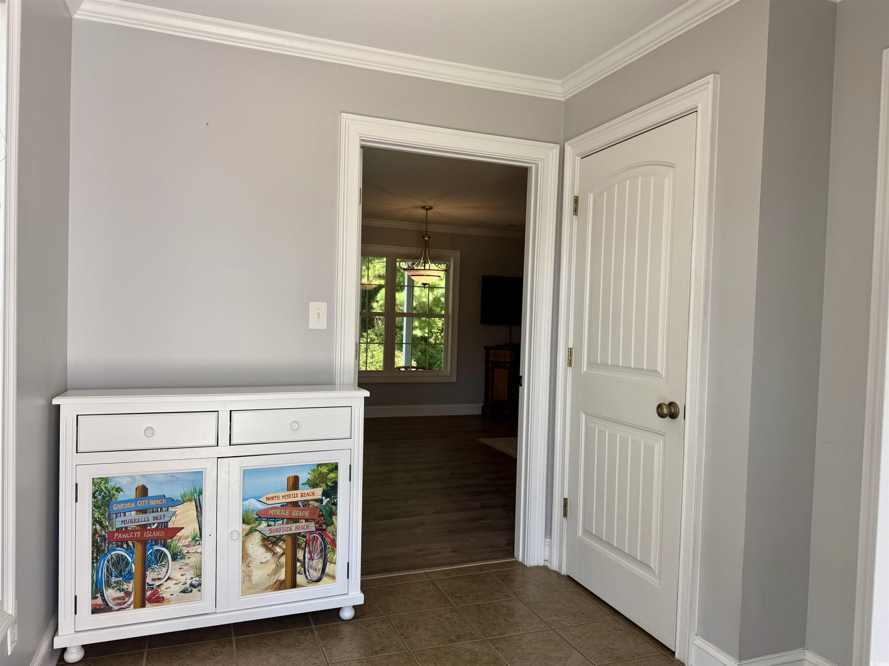 118 Georges Bay Road Murrells Inlet, SC 29576 - Photo 20 of 39 Hall with crown molding and dark tile patterned floors