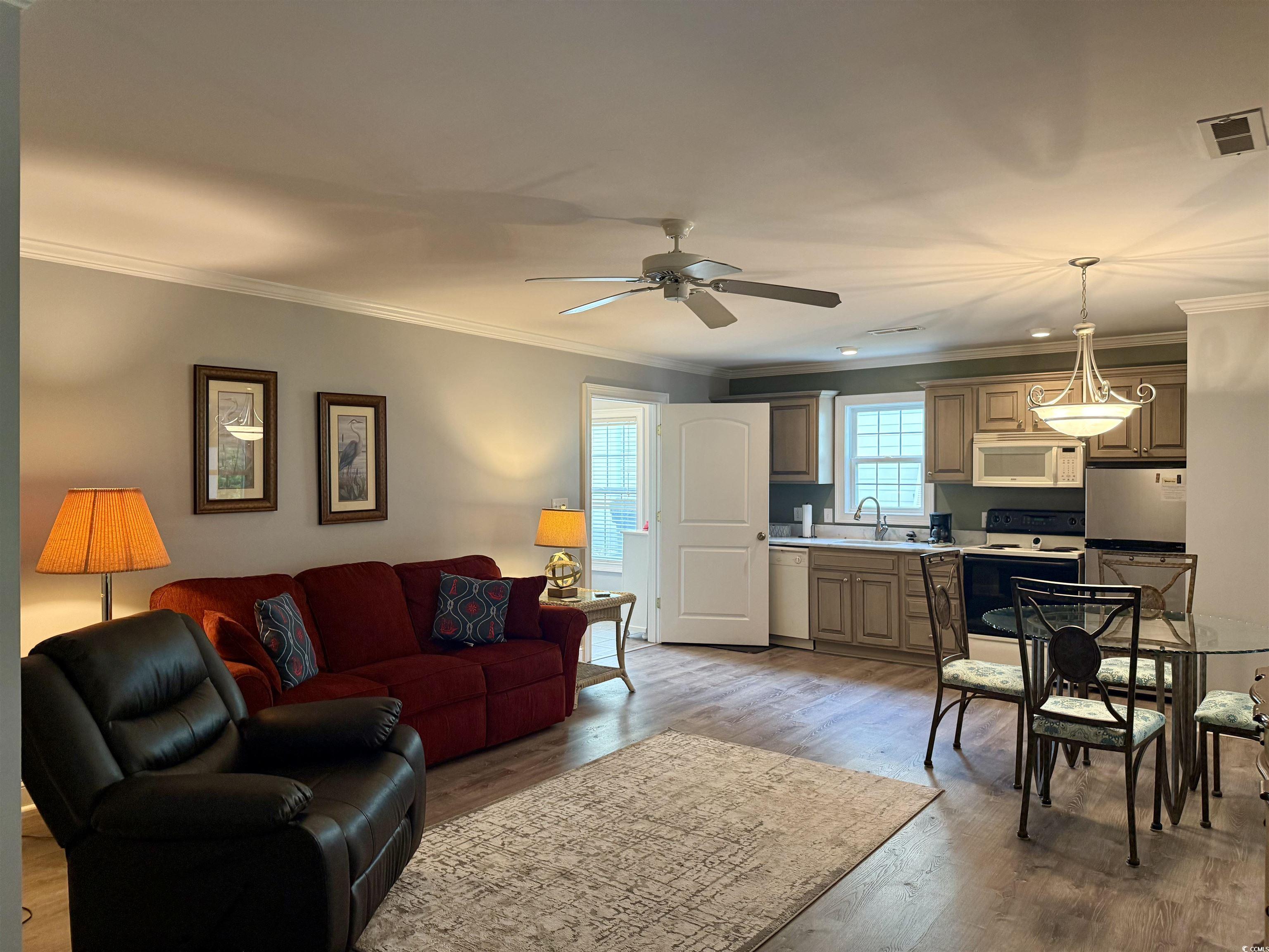 118 Georges Bay Road Murrells Inlet, SC 29576 - Photo 22 of 39 Living room featuring ornamental molding, light wood-style flooring, and a ceiling fan