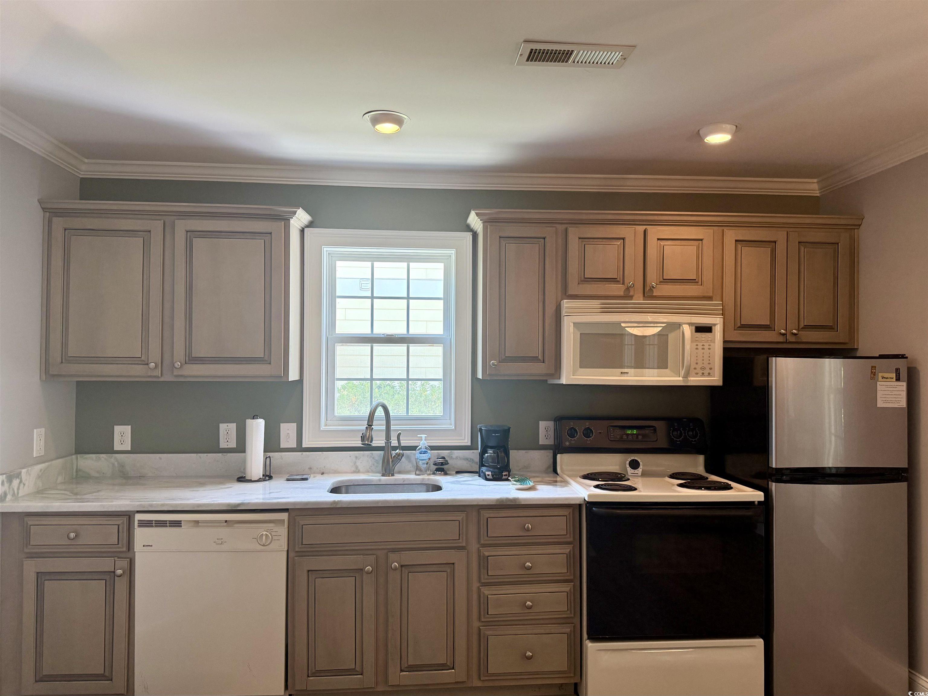 118 Georges Bay Road Murrells Inlet, SC 29576 - Photo 23 of 39 Kitchen featuring white appliances and crown molding