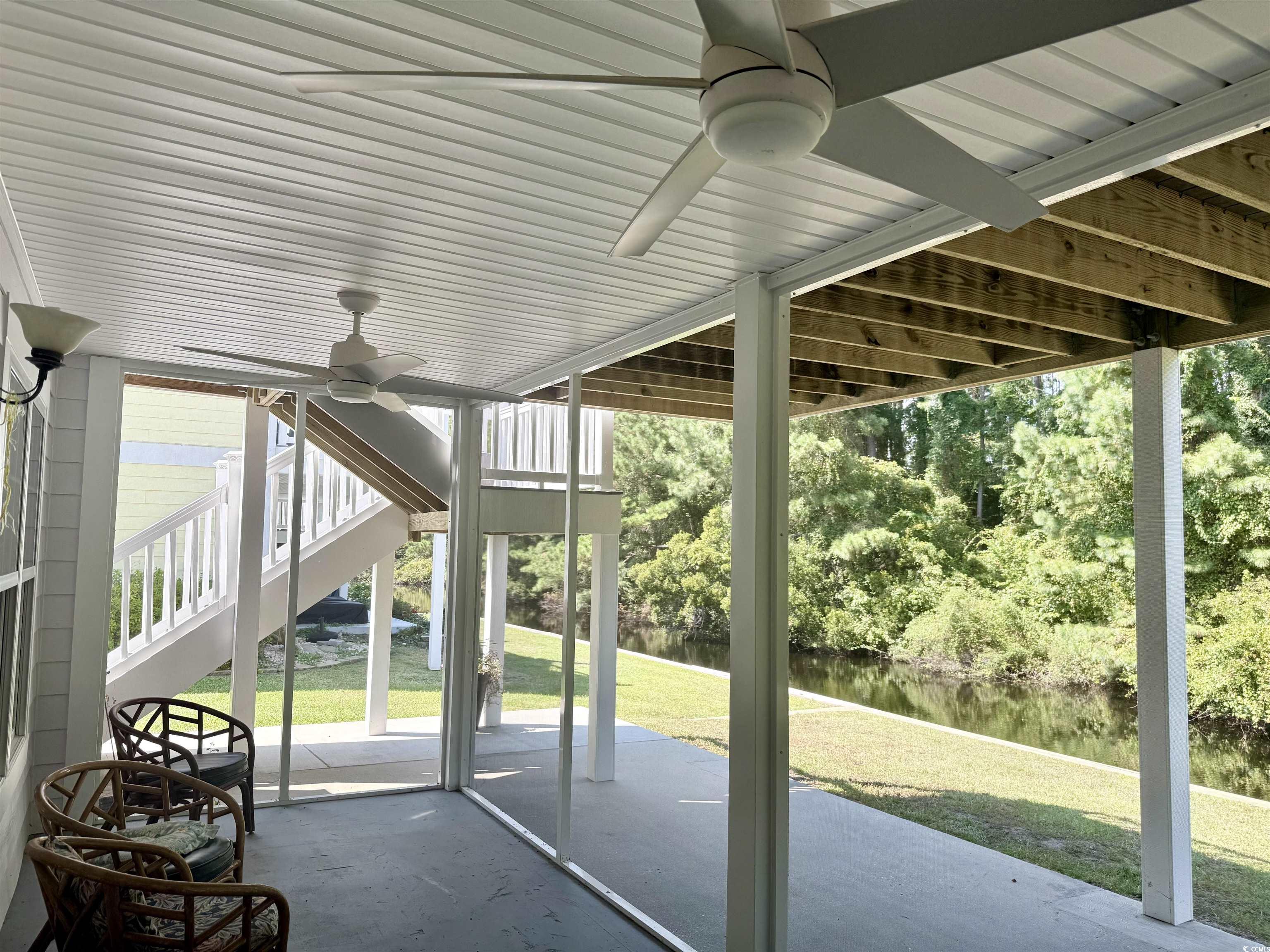 118 Georges Bay Road Murrells Inlet, SC 29576 - Photo 30 of 39 Unfurnished sunroom with ceiling fan, a patio, and a water view