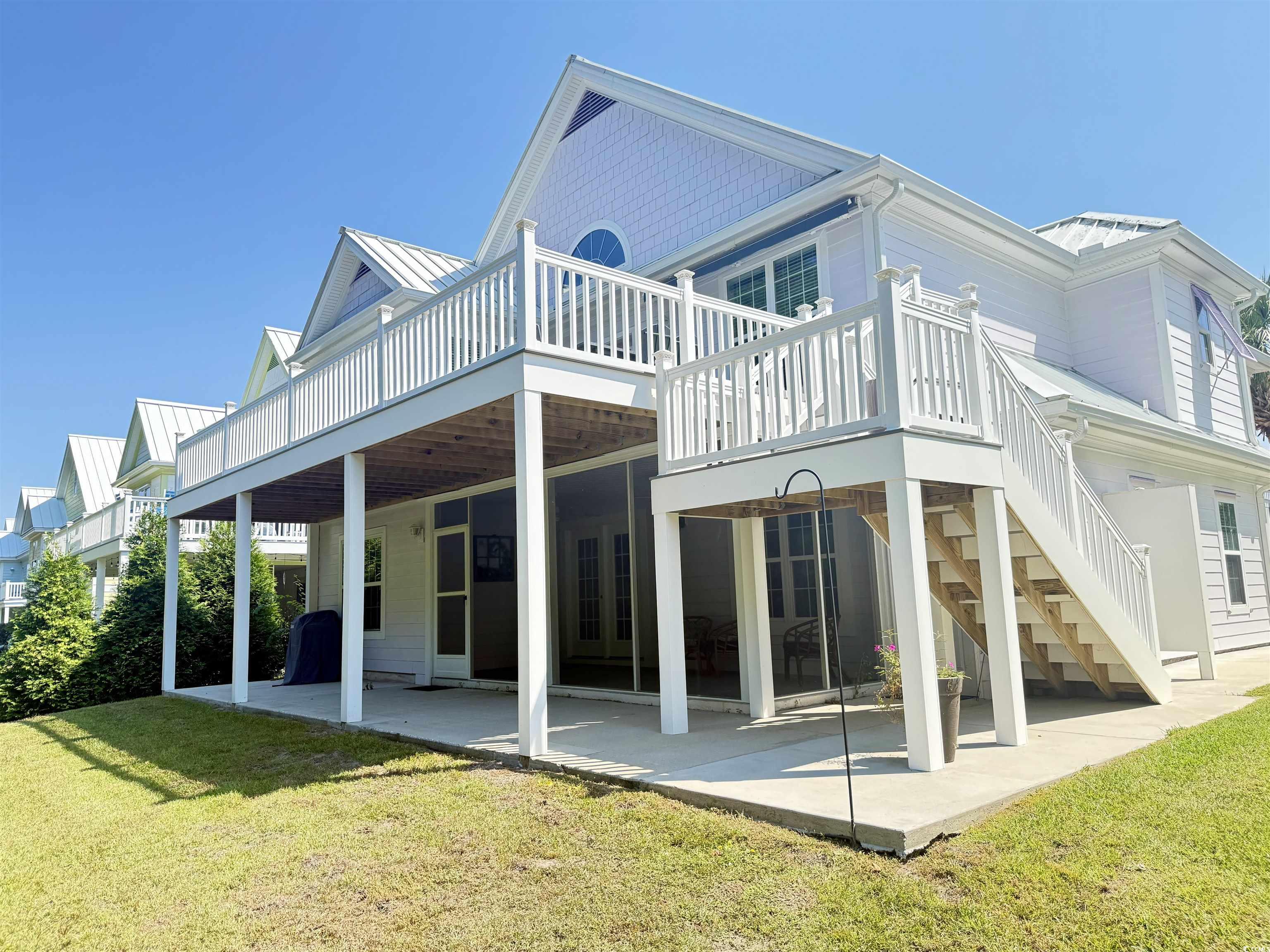 118 Georges Bay Road Murrells Inlet, SC 29576 - Photo 36 of 39 Back of property with a patio, a standing seam roof, a metal roof, and a yard