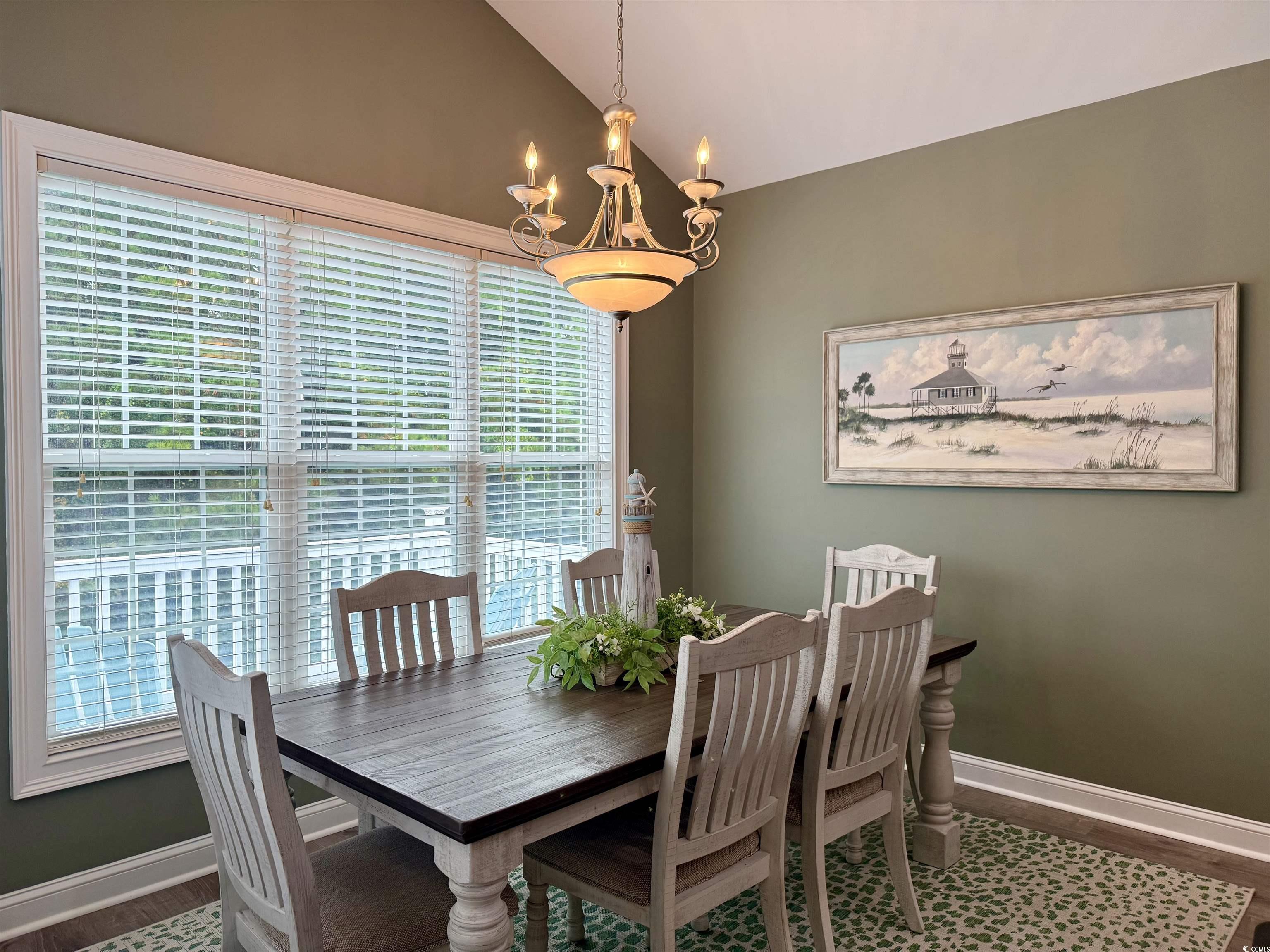 118 Georges Bay Road Murrells Inlet, SC 29576 - Photo 8 of 39 Dining space with lofted ceiling, a chandelier, and dark wood-style floors