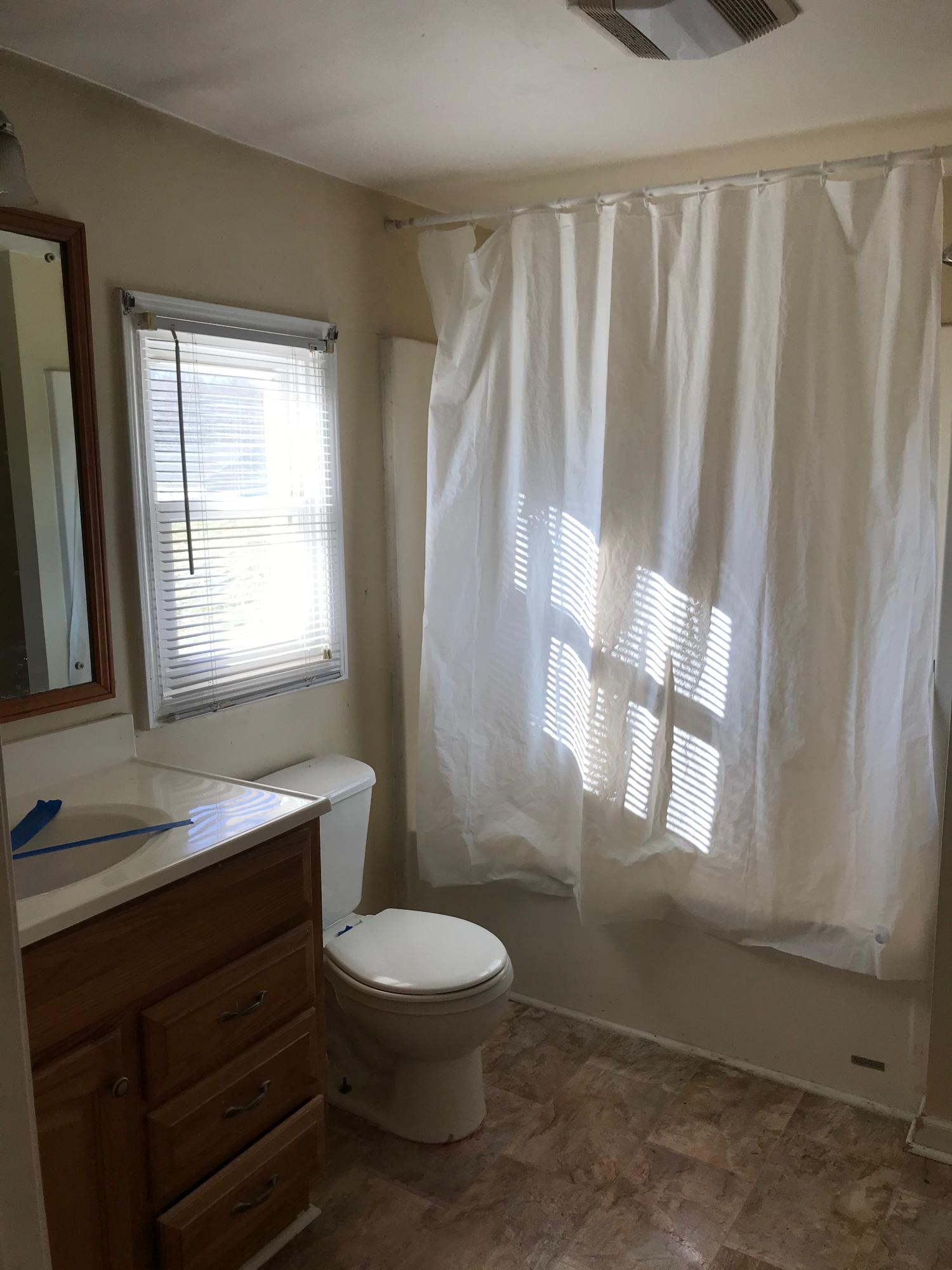 2553 Webster Road Roanoke, VA 24012 - Photo 7 of 29 a bathroom with a toilet a sink and a window