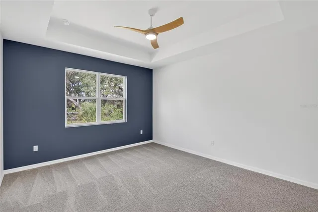 an empty room with closet and windows