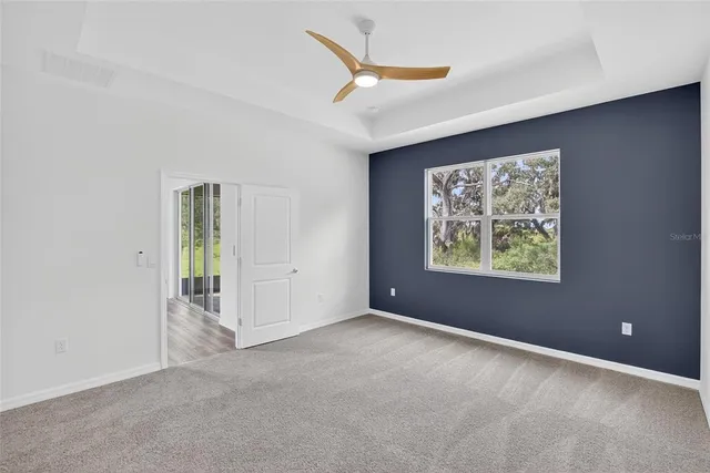 a bathroom with a granite countertop sink a toilet and a large mirror