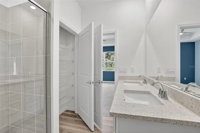 a bathroom with a granite countertop sink a toilet and a mirror