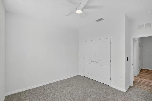 a front view of a house with a yard and potted plants