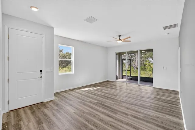 wooden floor in an empty room with a window