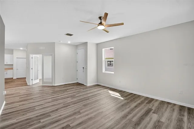 a view of a livingroom with a hall and wooden floor