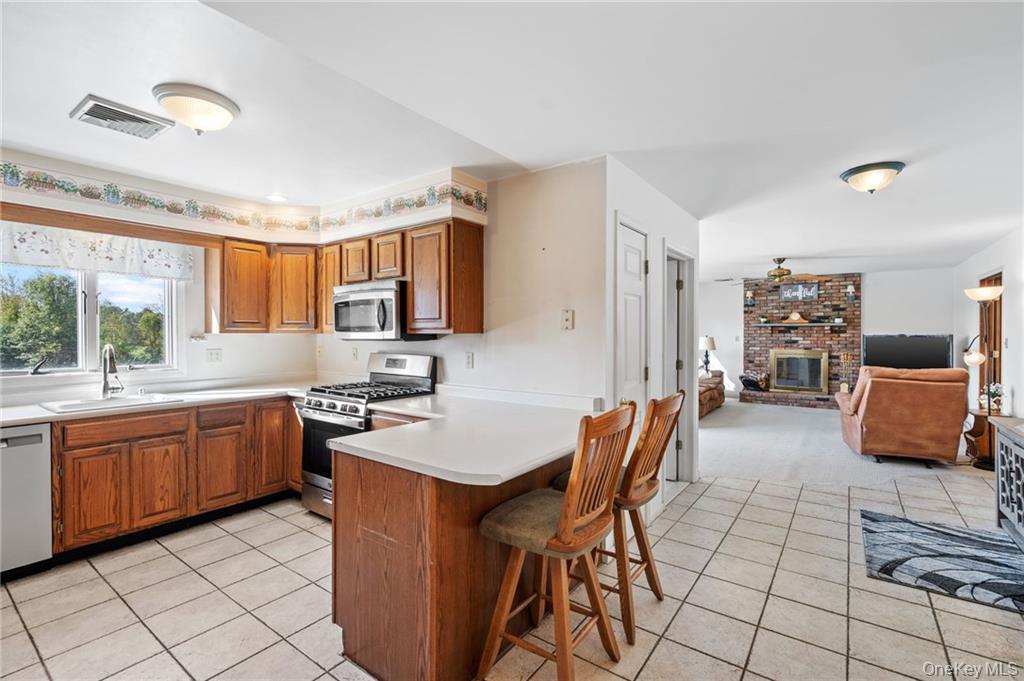 295 Borden Road Wallkill, NY 12589 - Photo 13 of 35 a kitchen with stainless steel appliances granite countertop sink stove top oven and cabinets
