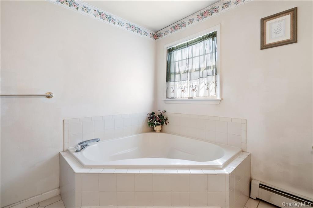 295 Borden Road Wallkill, NY 12589 - Photo 23 of 35 a white bath tub sitting in a bathroom