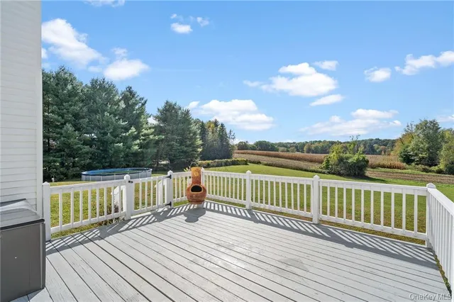 a view of a wooden deck with a yard