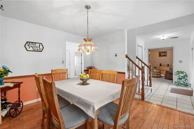 a view of a dining room with furniture wooden floor and chandelier