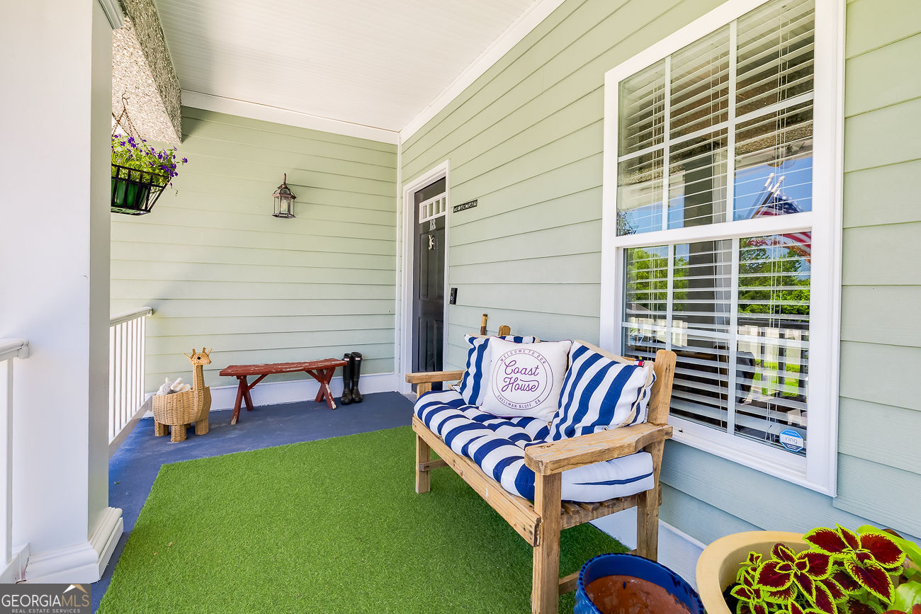 7272 Shellman Bluff Road Northeast, Unit 18 Townsend, GA 31331 - Photo 2 of 31 a outdoor living area with furniture and a potted plant